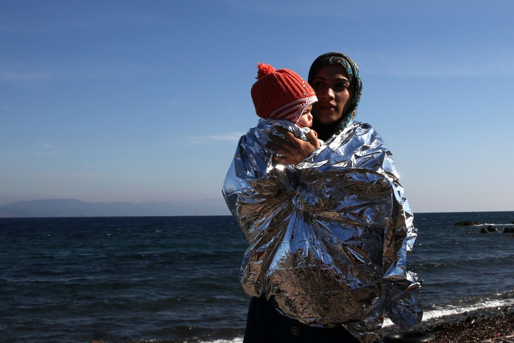 LESBOS, GREECE - OCTOBER 15: Refugees crossing the Aegean sea are seen after reaching the Greek island of Lesbos on October 15, 2015. Refugees who begin a journey with a hope to have high living standards away from conflicts, use Greece's Lesbos Island as a transit point on their way to Europe. (Photo by Ayhan Mehmet/Anadolu Agency/Getty Images)