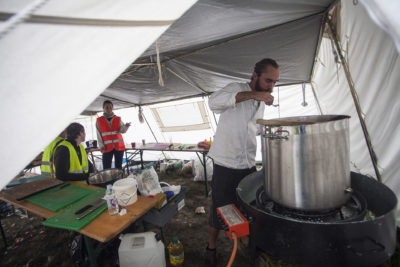 Victor Ullman, a 27-year old Swedish chef from Lundat,cooking a meal for refugees at  village of Bapska, Croatia on September 26, 2015. 'As long as I am awake, I am cooking,' he says. 'I have no perception of time here. No watch, no telephone.' All along the way refugees are met by an army of volunteers from across Europe, drawn by an overwhelming desire to help.