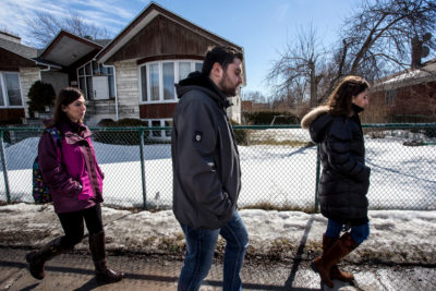Kevork Eleyjian, centre, and his sisters Lara, left, and Houry, right, walk down the streets of Laval, Quebec on Saturday, March 12, 2016. The three siblings use Saturday to take care of their household tasks. "I feel very welcome here," Kevork said. People at the airport all clapped when we arrived. ; Since November 4, 2015, 26,176 Syrian refugees have arrived in Canada, fleeing the war in Syria.
